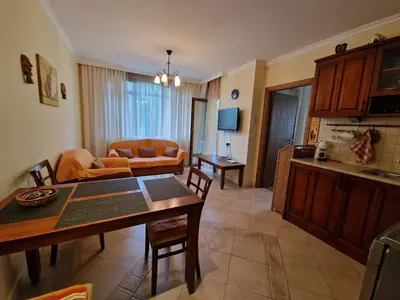 a living room with a table and a couch at Marina Trio in Sozopol
