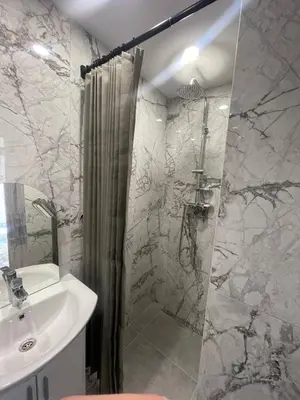 a bathroom with a shower and a sink at Aqva blue apartments in Sunny Beach