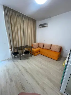 a living room with a couch and a table at Aqva blue apartments in Sunny Beach