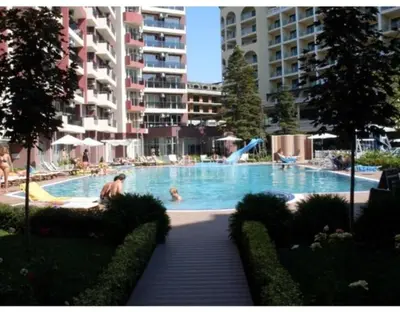 a large swimming pool with people in a hotel at Privite apartment hotel Admiral plaza in Sunny Beach