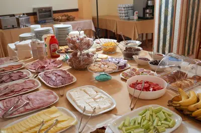a table topped with lots of different types of food at Hotel Smolyan in Sunny Beach