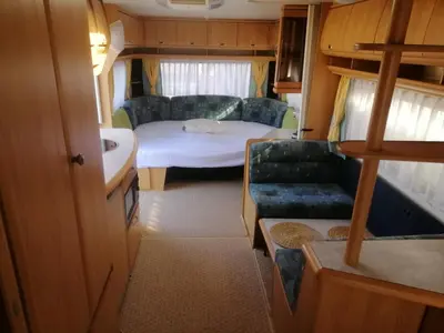 a small room with a bed and a couch at Каравана Сий-я-на in Sozopol