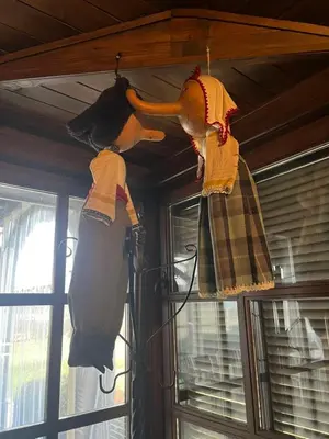 three dresses hanging from the ceiling of a room at Семеен хотел Звезда in Sŭdievo