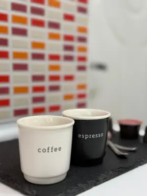 two coffee cups sitting on top of a table at Dayanas Suite in Varna City