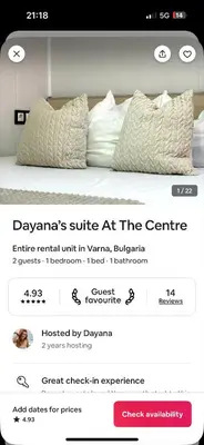 a page of a bed with two pillows on it at Dayanas Suite in Varna City