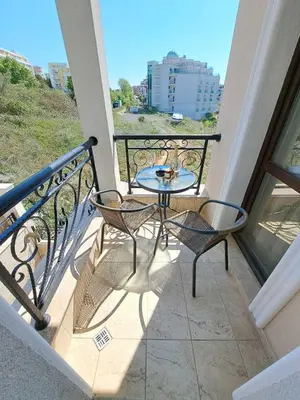 a balcony with a table and chairs on a balcony at Onyx Private Apartments in Sveti Vlas