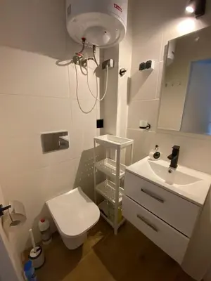 a bathroom with a white toilet and a sink at Avalon Lux in Sunny Beach