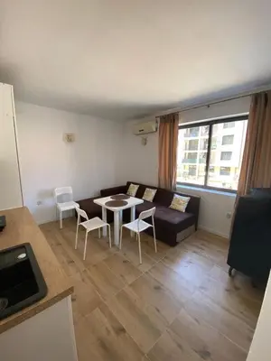 a living room with a couch and a table and chairs at Avalon Lux in Sunny Beach