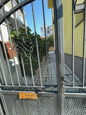 a metal door with a sign in front of a building at Studio 007 с градинка in Burgas City