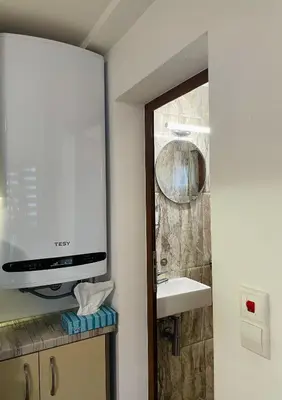 a bathroom with a sink and a mirror at Studio 007 с градинка in Burgas City