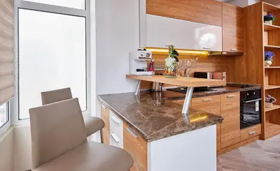 a kitchen with a wooden counter and a table at Luxury Apartment Saint George Beauty and Style in Sveti Vlas