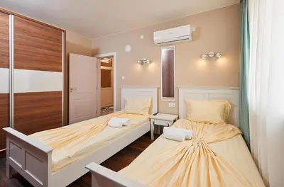 a bedroom with two beds and a window at Luxury Apartment Saint George Beauty and Style in Sveti Vlas