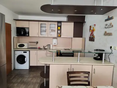 a kitchen with a table and a counter top at Nev 1 in Burgas City