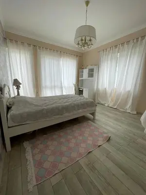 a bedroom with a bed and a rug and windows at Luxury Villa in Sozopol in Sozopol