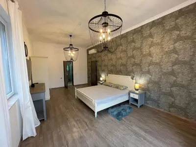 a bedroom with a bed and two tables and two lights at Luxury Villa in Sozopol in Sozopol