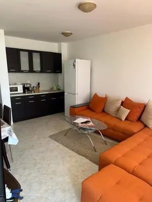 a living room with a couch and a table at Apartament Sunset Kosharitsa - Slunchev briag in Kosharitsa