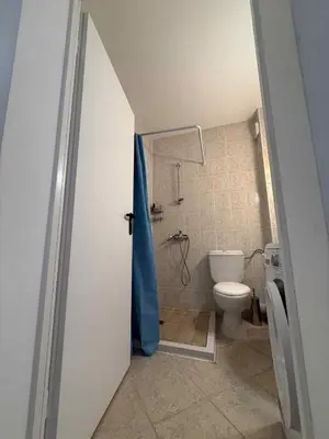 a small bathroom with a toilet and a shower at Apartament Sunset Kosharitsa - Slunchev briag in Kosharitsa