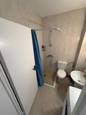 a bathroom with a shower and a toilet and a sink at Apartament Sunset Kosharitsa - Slunchev briag in Kosharitsa