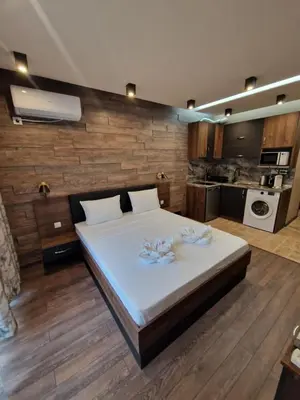 a bedroom with a bed with two flowers on it at MitProt Panorama Bay 2 Luks Studio 29 in Sveti Vlas