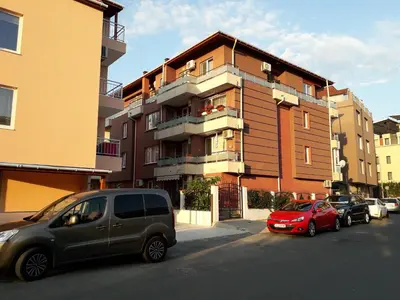 a group of cars parked in front of a building at Apartment Rosa Marina in Nesebar