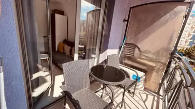 a balcony with chairs and a table on a balcony at Rainbow 3-213 Large Studio Delux in Sunny Beach