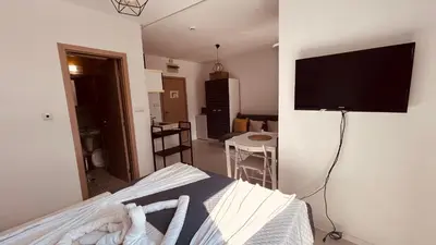 a bedroom with a bed and a flat screen tv at Rainbow 3-213 Large Studio Delux in Sunny Beach