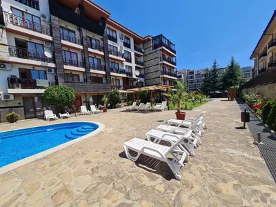 a row of lounge chairs next to a swimming pool at MitProt Panorama bay 2 Luks Apartment 175 in Sveti Vlas