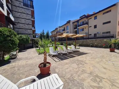 a group of chairs and umbrellas in a courtyard at MitProt Panorama Bay 2 luks Studio 143 in Sveti Vlas
