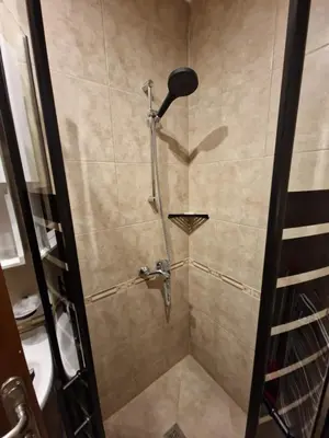 a shower with a shower head in a bathroom at MitProt Panorama Bay 2 luks Studio 143 in Sveti Vlas