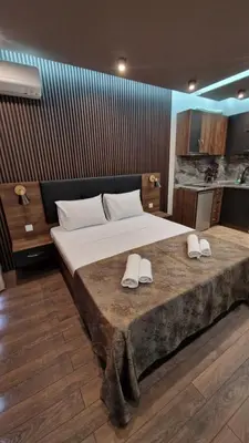 a bedroom with a large bed with slippers on it at MitProt Panorama Bay 2 luks Studio 143 in Sveti Vlas