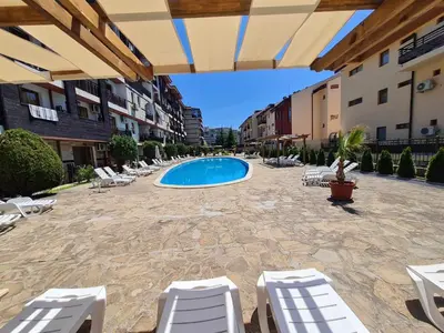 a patio with lounge chairs and a swimming pool at MitProt Panorama Bay 2 luks Studio 143 in Sveti Vlas