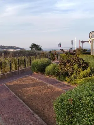 a brick walkway with a fence and plants at Studio Quatro - South Pearl - Sozopol in Sozopol