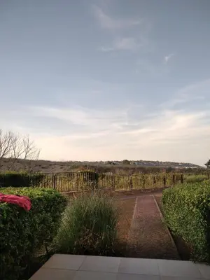 a garden with a fence in the distance at Studio Quatro - South Pearl - Sozopol in Sozopol