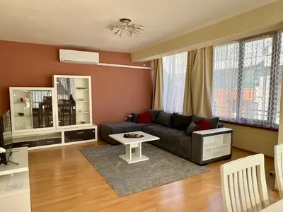 a living room with a couch and a table at Sunny View Apartment with Garage in Burgas City