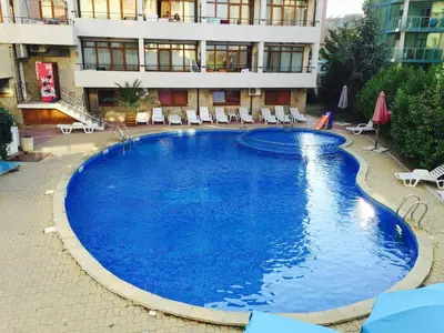 a large swimming pool in front of a building at Stamopolu apartament 1 in Primorsko