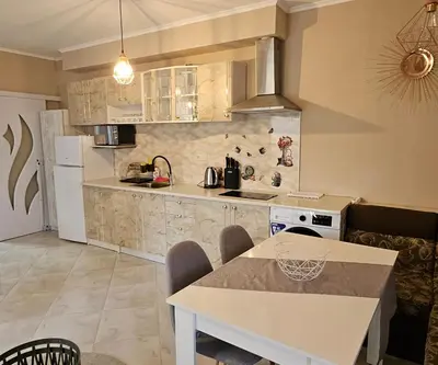 a kitchen with a table and a counter top at Sunny Garden Deluxe in Burgas City