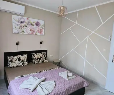a bedroom with a bed with two towels on it at Sunny Garden Deluxe in Burgas City