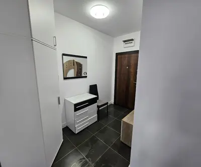 a room with a desk and a cabinet and a door at Rose Garden Deluxe in Chernomorets