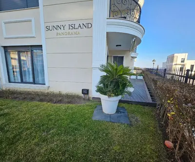 a plant in a pot in front of a building at Rose Garden Deluxe in Chernomorets