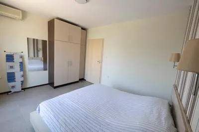 a small bedroom with a bed and a closet at Reina Apart Kamelia Garden in Sunny Beach