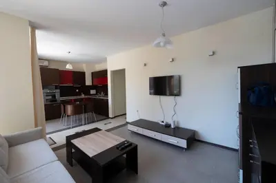 a living room with a couch and a table at Reina Apart Kamelia Garden in Sunny Beach