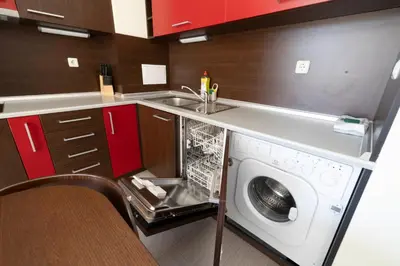 a washing machine in a kitchen with a sink at Reina Apart Kamelia Garden in Sunny Beach
