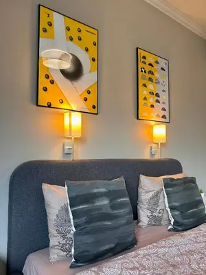 a living room with a couch and a painting on the wall at Sea Breeze l 2BD Sea Garden Apartment in Varna City