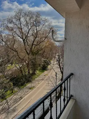 a balcony with a view of a street and trees at Sea Breeze l 2BD Sea Garden Apartment in Varna City