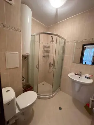 a bathroom with a shower and a toilet and a sink at Cascadas Family Resort in Sunny Beach