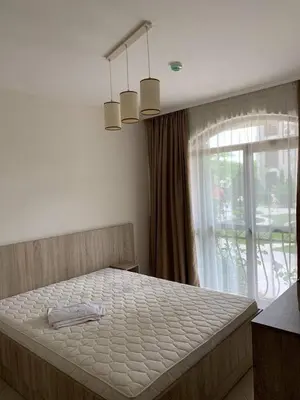 a large bed in a bedroom with a window at Cascadas Family Resort in Sunny Beach