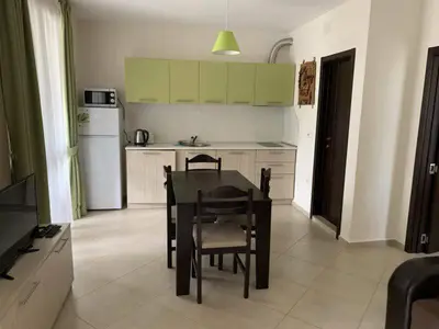 a kitchen with a table and chairs in a room at Cascadas Family Resort in Sunny Beach