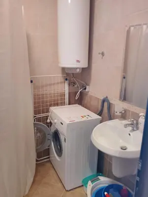 a small bathroom with a washing machine and a sink at Studio in Sea Breeze Complex Sveti Vlas in Sveti Vlas