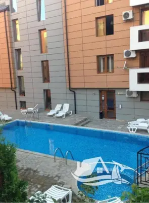 a swimming pool in front of a building at Studio in Sea Breeze Complex Sveti Vlas in Sveti Vlas