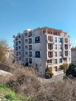 a tall apartment building on the side of a hill at Studio Apartment Villa Sardinia Sveti Vlas in Sveti Vlas
